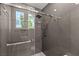 Sleek shower featuring glass door, overhead shower head, and built-in niche at 2293 Buckingham Ct, Henderson, NV 89074