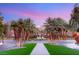 Well-maintained street with palm trees lining the way, leading to a picturesque water fountain at 2293 Buckingham Ct, Henderson, NV 89074