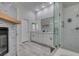 Elegant bathroom with modern finishes, double vanity, walk-in shower, and a cozy fireplace at 230 Pintale Cir, Henderson, NV 89074