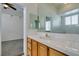 Bright bathroom features a single sink vanity and a view into the carpeted walk-in closet at 230 Pintale Cir, Henderson, NV 89074