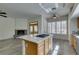 Open floor plan showing kitchen island with cooktop, and living area with fireplace at 230 Pintale Cir, Henderson, NV 89074