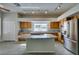 Well-lit kitchen featuring an island with a cooktop, stainless steel appliances and granite countertops at 230 Pintale Cir, Henderson, NV 89074