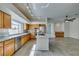 Open-concept kitchen featuring stainless steel appliances, granite countertops, and a center island with cooktop at 230 Pintale Cir, Henderson, NV 89074