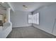 Living room featuring neutral carpet and natural light from the shuttered windows at 230 Pintale Cir, Henderson, NV 89074