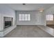 Spacious living room boasting a fireplace, plantation shutters, and neutral carpeting at 230 Pintale Cir, Henderson, NV 89074