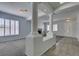 Neutral living room with shuttered windows, decorative pillars, and grey carpet at 230 Pintale Cir, Henderson, NV 89074