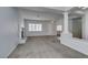 Living room featuring grey carpet, decorative pillars, and natural light at 230 Pintale Cir, Henderson, NV 89074