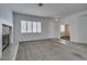 Open living room with fireplace, window shutters, tile entrance, and neutral carpet floors at 230 Pintale Cir, Henderson, NV 89074