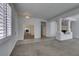 Bright living room featuring neutral colors, tile flooring, and decorative pillars at 230 Pintale Cir, Henderson, NV 89074