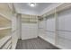 Large walk-in closet featuring built-in shelving, drawers, and rods for efficient storage at 230 Pintale Cir, Henderson, NV 89074