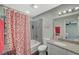 This full bathroom has a shower-tub combination with a charming strawberry-themed shower curtain at 2451 N Rainbow Blvd # 2076, Las Vegas, NV 89108