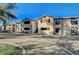 Exterior shot of a multi-story tan residential building with stairs leading to the second floor at 2451 N Rainbow Blvd # 2076, Las Vegas, NV 89108