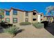 Exterior image of a two-story condo building featuring lush landscaping and mature trees at 2451 N Rainbow Blvd # 2076, Las Vegas, NV 89108