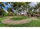 A lovely green area with walking path surrounded by mature trees and plants at 2451 N Rainbow Blvd # 2076, Las Vegas, NV 89108