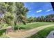 Scenic view of lush community grounds featuring mature trees and a walking path at 2451 N Rainbow Blvd # 2076, Las Vegas, NV 89108