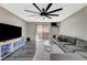 Modern living room with a gray sofa, entertainment center with LED lights, and a ceiling fan at 2451 N Rainbow Blvd # 2076, Las Vegas, NV 89108