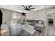 Living room with modern decor, a ceiling fan, sliding door to a patio, and gray wood floors at 2451 N Rainbow Blvd # 2076, Las Vegas, NV 89108