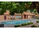 Community pool with beautiful landscaping, lounge chairs and covered area at 2451 N Rainbow Blvd # 2076, Las Vegas, NV 89108