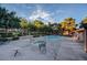 Outdoor community pool and spa with plenty of seating and mature landscaping at 2451 N Rainbow Blvd # 2076, Las Vegas, NV 89108