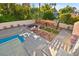 Backyard view showcasing pool, trampoline, and an outdoor living space surrounded by lush trees at 2501 Wimbledon Dr, Las Vegas, NV 89107