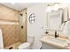 Bathroom featuring decorative tiled shower, sleek fixtures, and modern vanity with round window at 2501 Wimbledon Dr, Las Vegas, NV 89107