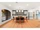 Elegant dining room with unique lighting, bar area, and a large window with a view of the front yard at 2501 Wimbledon Dr, Las Vegas, NV 89107