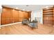 Elegant living room featuring wood paneling, bookshelves, and stylish seating at 2501 Wimbledon Dr, Las Vegas, NV 89107