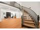 Elegant curved staircase with hardwood steps and a dark gray railing leading to the upper level at 2501 Wimbledon Dr, Las Vegas, NV 89107