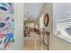 Inviting entryway featuring a decorative mirror, console table, and an open view into the living and dining areas at 2537 Nashira St, Henderson, NV 89044