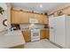 Well-lit kitchen equipped with plenty of cabinet space, a gas stove, and white appliances at 2537 Nashira St, Henderson, NV 89044