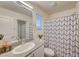 Clean and functional bathroom featuring a shower with modern patterned curtain and neutral tones at 2657 Fawn Beige Ct, North Las Vegas, NV 89086