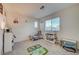 Bright bedroom featuring neutral walls, carpet, and a sunny window at 2657 Fawn Beige Ct, North Las Vegas, NV 89086