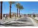 Gated community entrance with palm trees, landscaped walkway, and a secure access point, offering privacy and curb appeal at 2657 Fawn Beige Ct, North Las Vegas, NV 89086