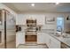 Modern kitchen features stainless steel appliances, white cabinets and beautiful granite countertops at 2657 Fawn Beige Ct, North Las Vegas, NV 89086