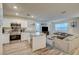 Open-concept living area with a modern kitchen, comfortable seating, and stylish decor at 2657 Fawn Beige Ct, North Las Vegas, NV 89086