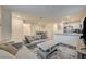 Open-concept living area with a cozy gray sofa, stylish coffee table, and views of the dining area and kitchen at 2657 Fawn Beige Ct, North Las Vegas, NV 89086