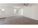 Spacious living room with neutral carpet, a ceiling fan, and lots of natural light at 2728 Pavehawk Way, Las Vegas, NV 89156