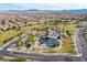 An aerial view of a beautiful neighborhood park with lush landscaping, water features, and mountain views at 2812 Dotted Wren Ave, North Las Vegas, NV 89084