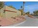 Community sign with desert landscaping, mature trees, and a wide sidewalk at 2812 Dotted Wren Ave, North Las Vegas, NV 89084