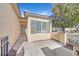 Exterior view of home featuring neutral stucco, shuttered windows, and concrete walkway to entry at 2812 Dotted Wren Ave, North Las Vegas, NV 89084