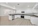 Modern kitchen featuring white cabinets, stainless steel appliances, and gray countertops at 2812 Dotted Wren Ave, North Las Vegas, NV 89084