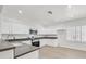 Updated kitchen featuring white cabinetry, gray countertops, and stainless steel appliances at 2812 Dotted Wren Ave, North Las Vegas, NV 89084