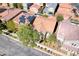 Drone shot capturing a home with solar panels, surrounded by lush landscaping in a quiet residential area at 3204 Romanesque Art Ave, Henderson, NV 89044