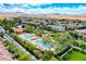 An aerial shot showcases the community pool area, surrounded by lush trees and greenery at 3204 Romanesque Art Ave, Henderson, NV 89044