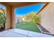 Inviting backyard featuring a well-manicured lawn and a private, covered patio at 3204 Romanesque Art Ave, Henderson, NV 89044