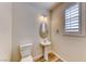 Powder room featuring a pedestal sink and toilet, wood-look flooring at 3204 Romanesque Art Ave, Henderson, NV 89044