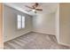 Bedroom with a ceiling fan, carpet flooring and window with shutters at 3204 Romanesque Art Ave, Henderson, NV 89044