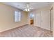 Neutral bedroom with a ceiling fan, carpet flooring and closet at 3204 Romanesque Art Ave, Henderson, NV 89044