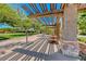 Inviting community space with shaded seating, lush landscaping, and pedestrian walkways under a trellis at 3204 Romanesque Art Ave, Henderson, NV 89044