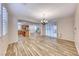 Open-concept dining room with wood-look floors, seamlessly connected to the kitchen at 3204 Romanesque Art Ave, Henderson, NV 89044